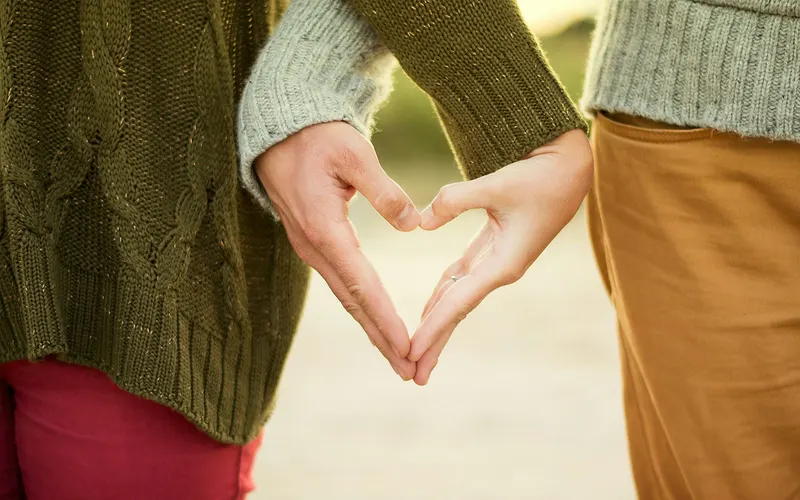 Two hands making a heart shape together