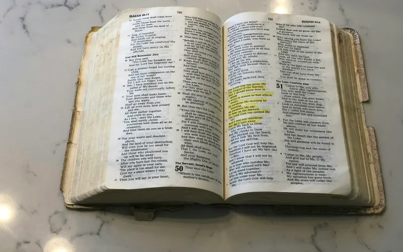 A Bible open on a marble table with highlighted verses