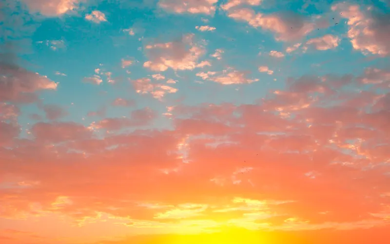 Clouds glowing at sunrise over the horizon