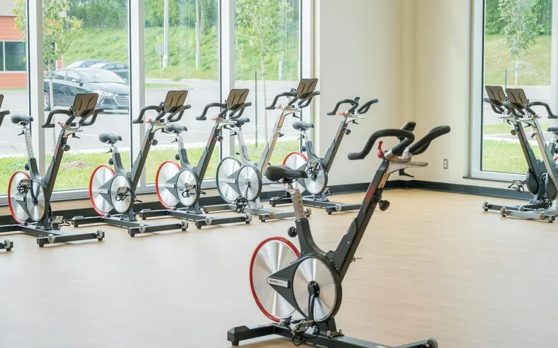 A row of spin bikes in a bright studio