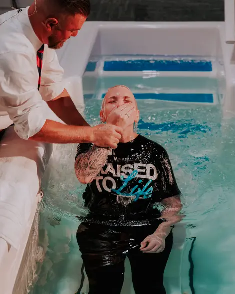 A pastor baptizing a new believer in the Victory baptism pool