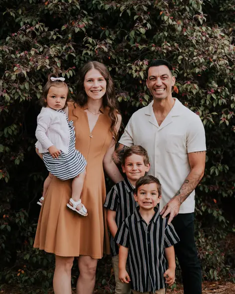 A young family together outside after church