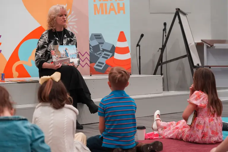 A kids leader reading to children in the kids wing