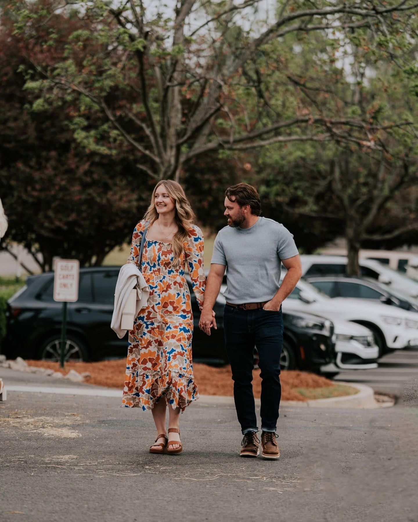 A couple walking in together from the parking lot on a Sunday morning