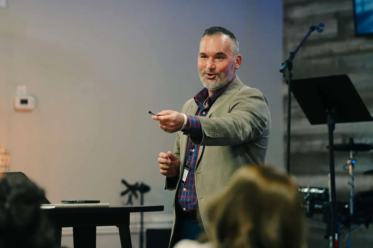 A ministry leader teaching from the front of a Victory Baptist College class