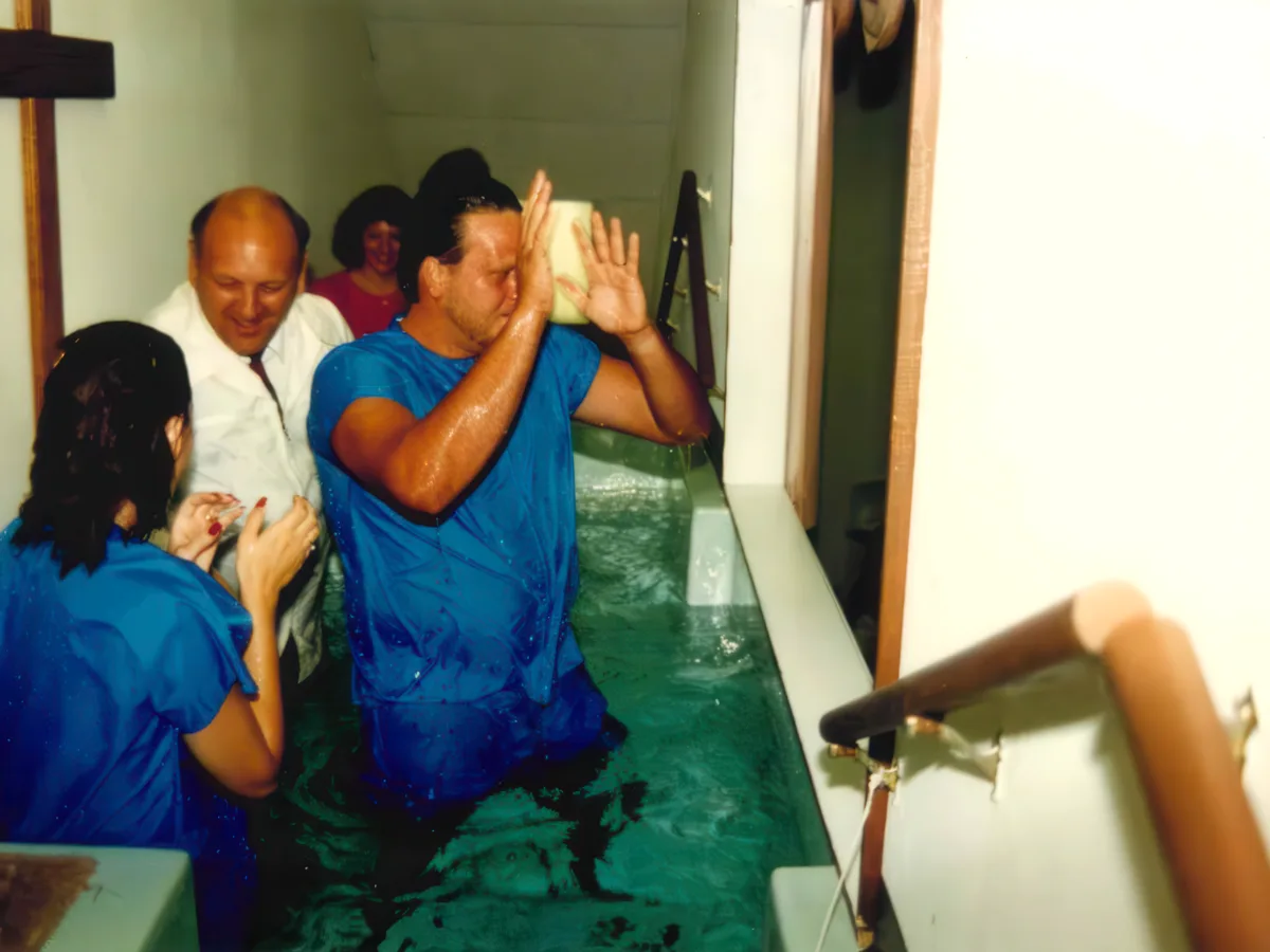 Dr. Brown baptizing a man by full immersion in the baptistry