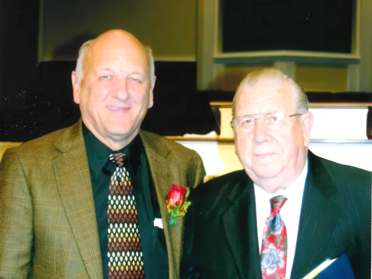 Dr. R. Larry Brown standing with another man in the sanctuary