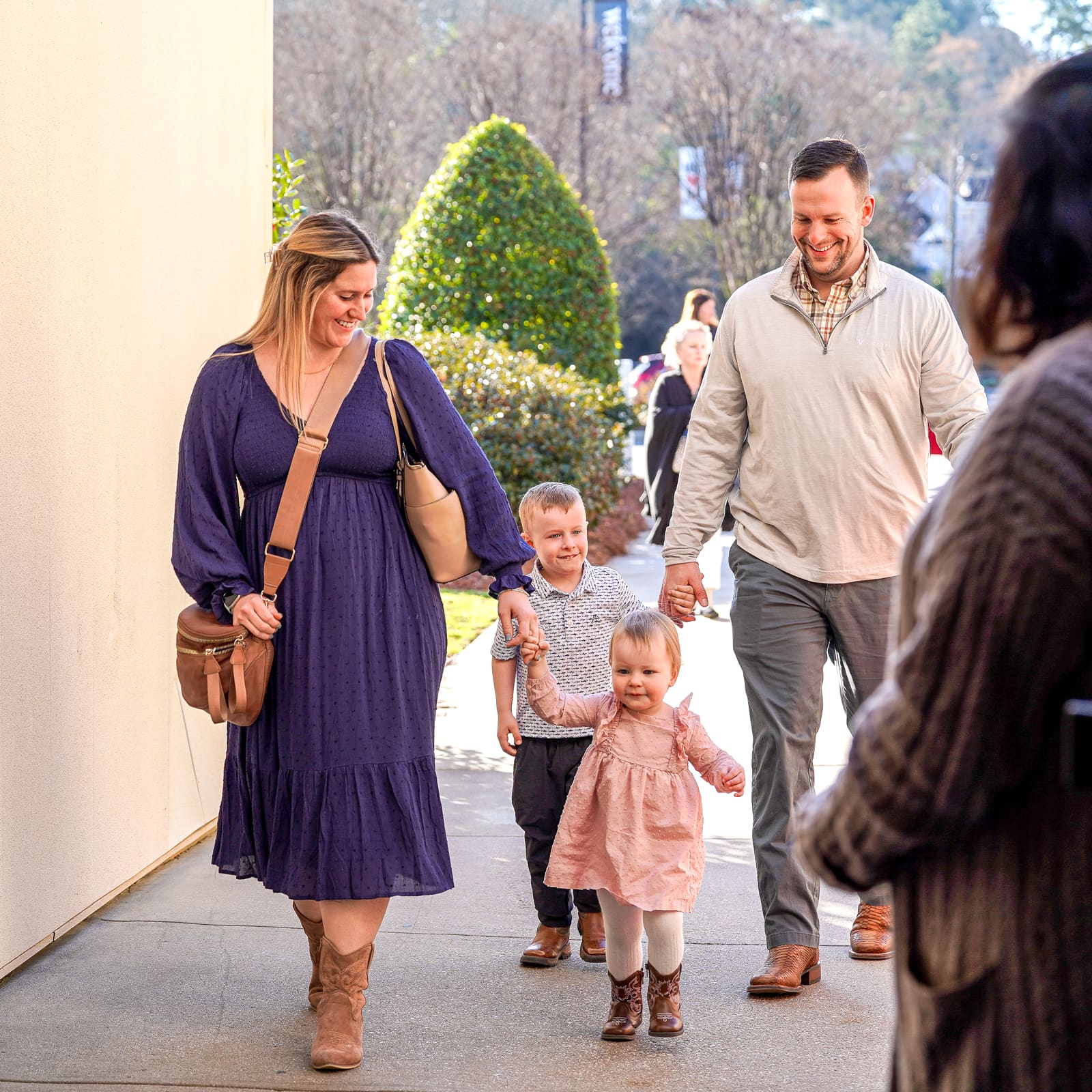 A young family walking in together on a Sunday morning