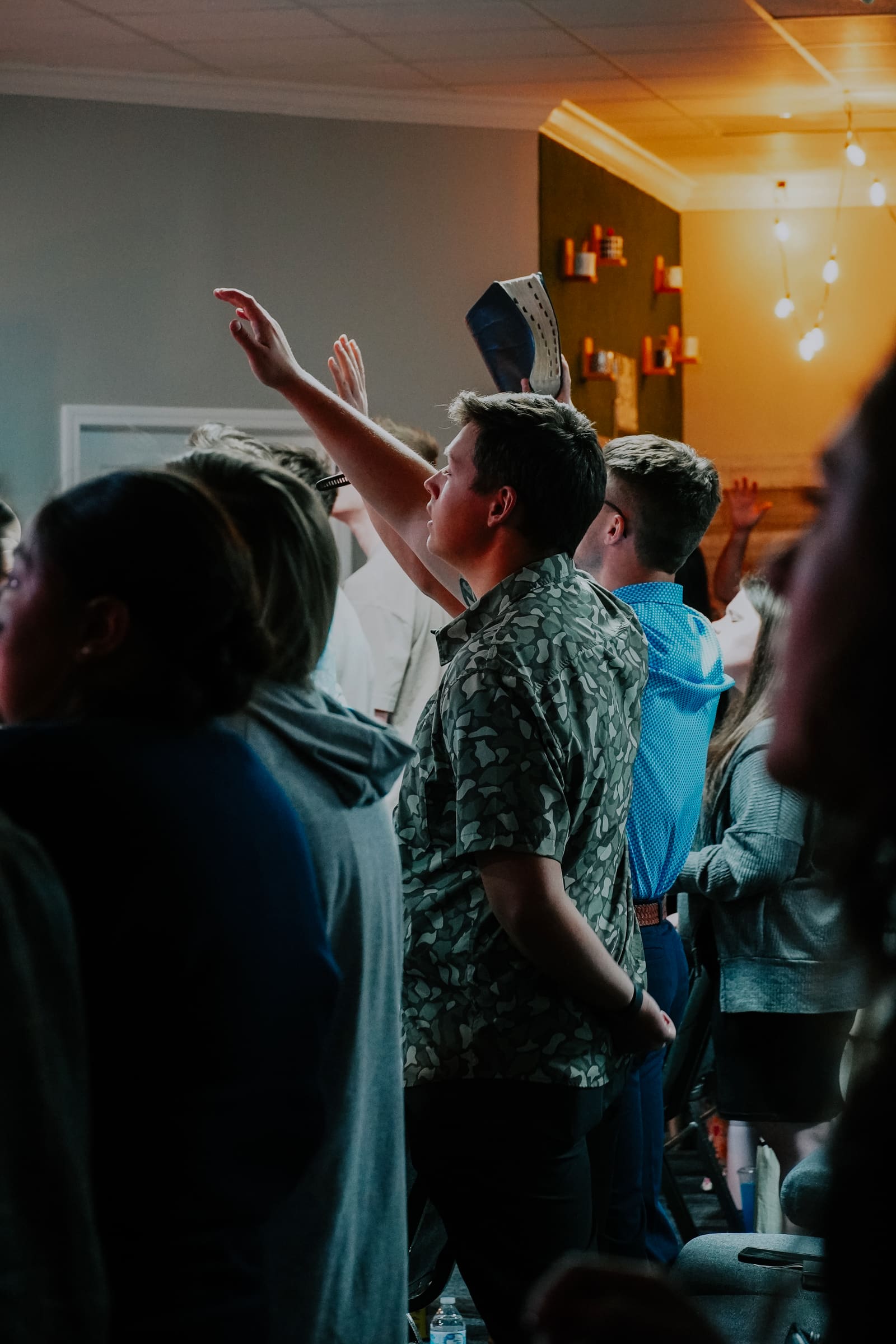 Adults with their hands raised during worship