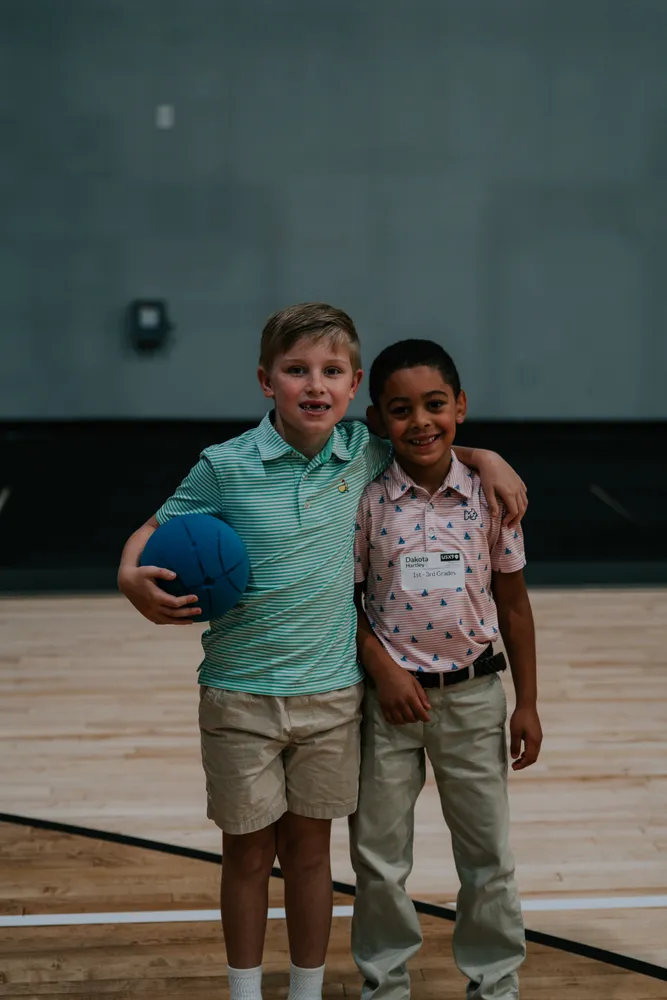Two boys with a basketball in the Victory gym