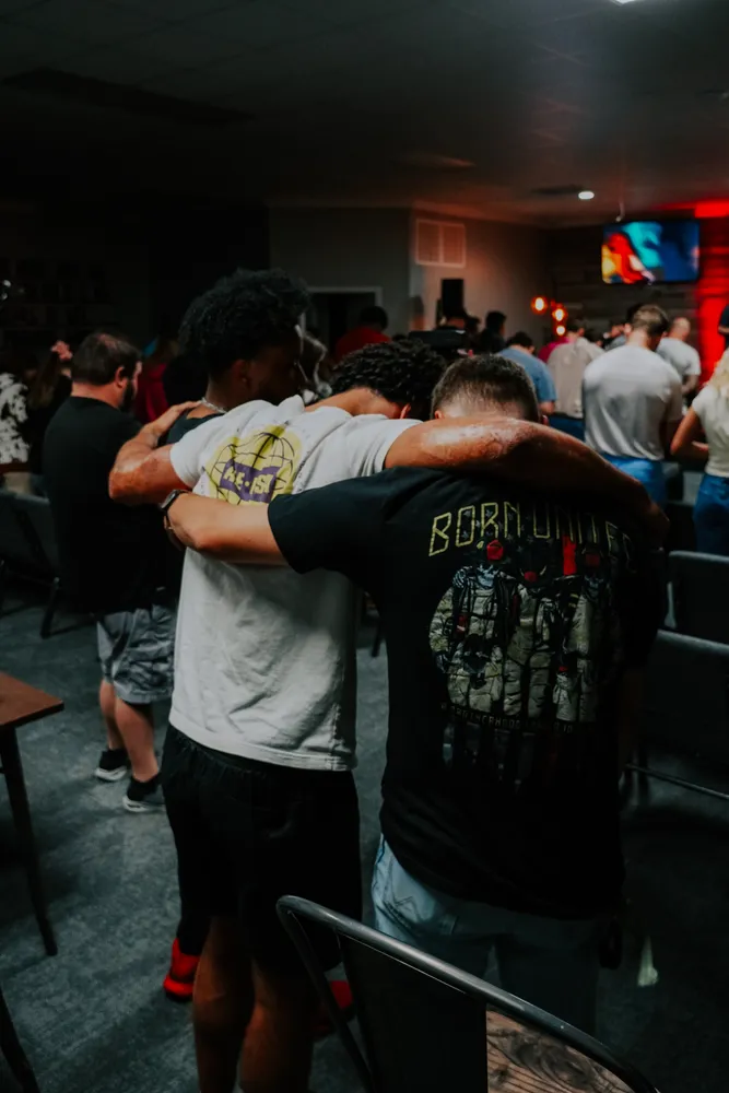 Two young men embracing at a Victory Young Adults gathering