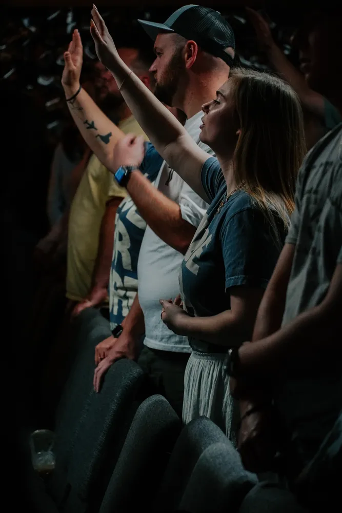 Young adults with their hands raised in worship