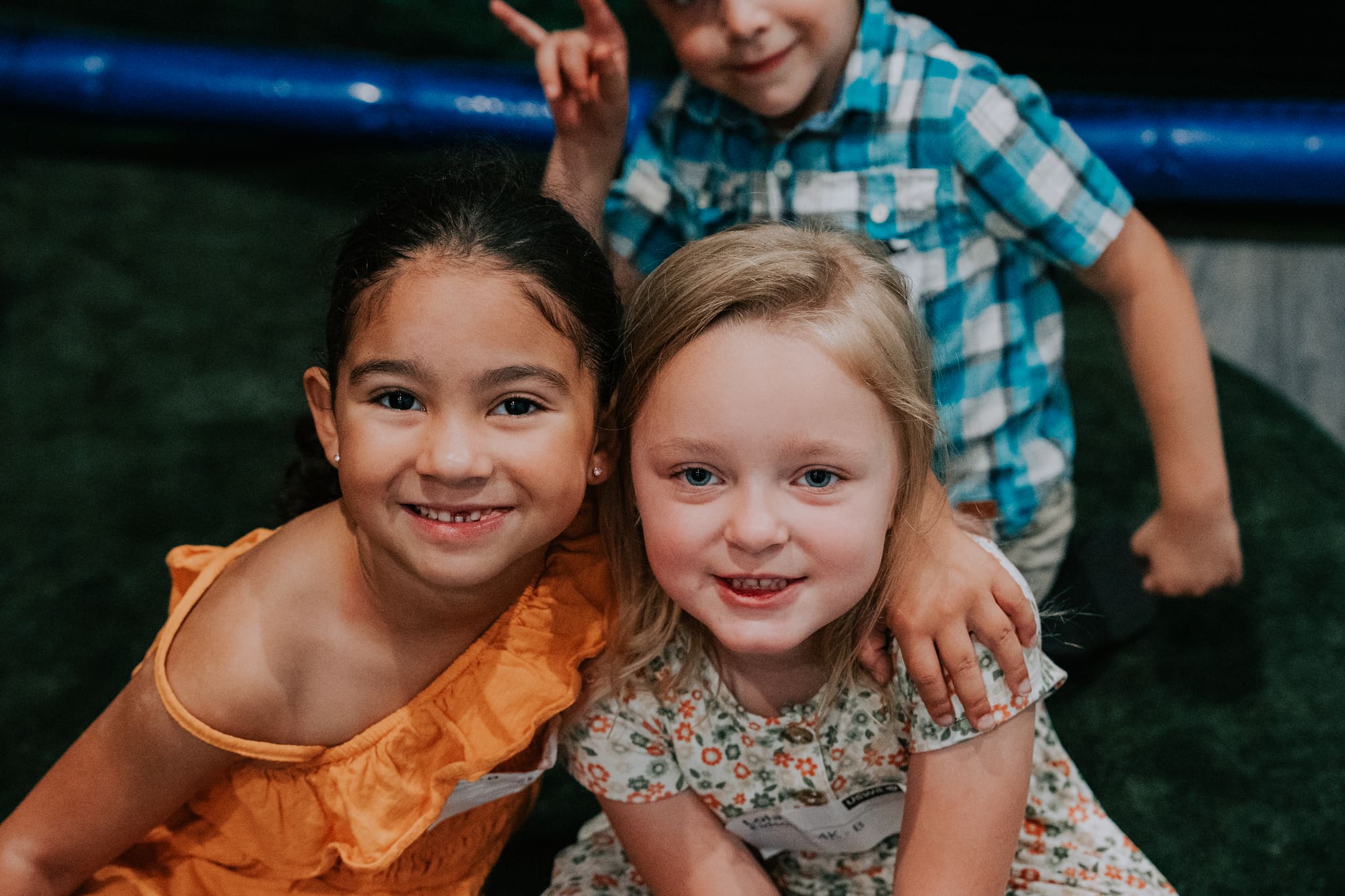Two girls hugging and smiling in the Victory Kids room