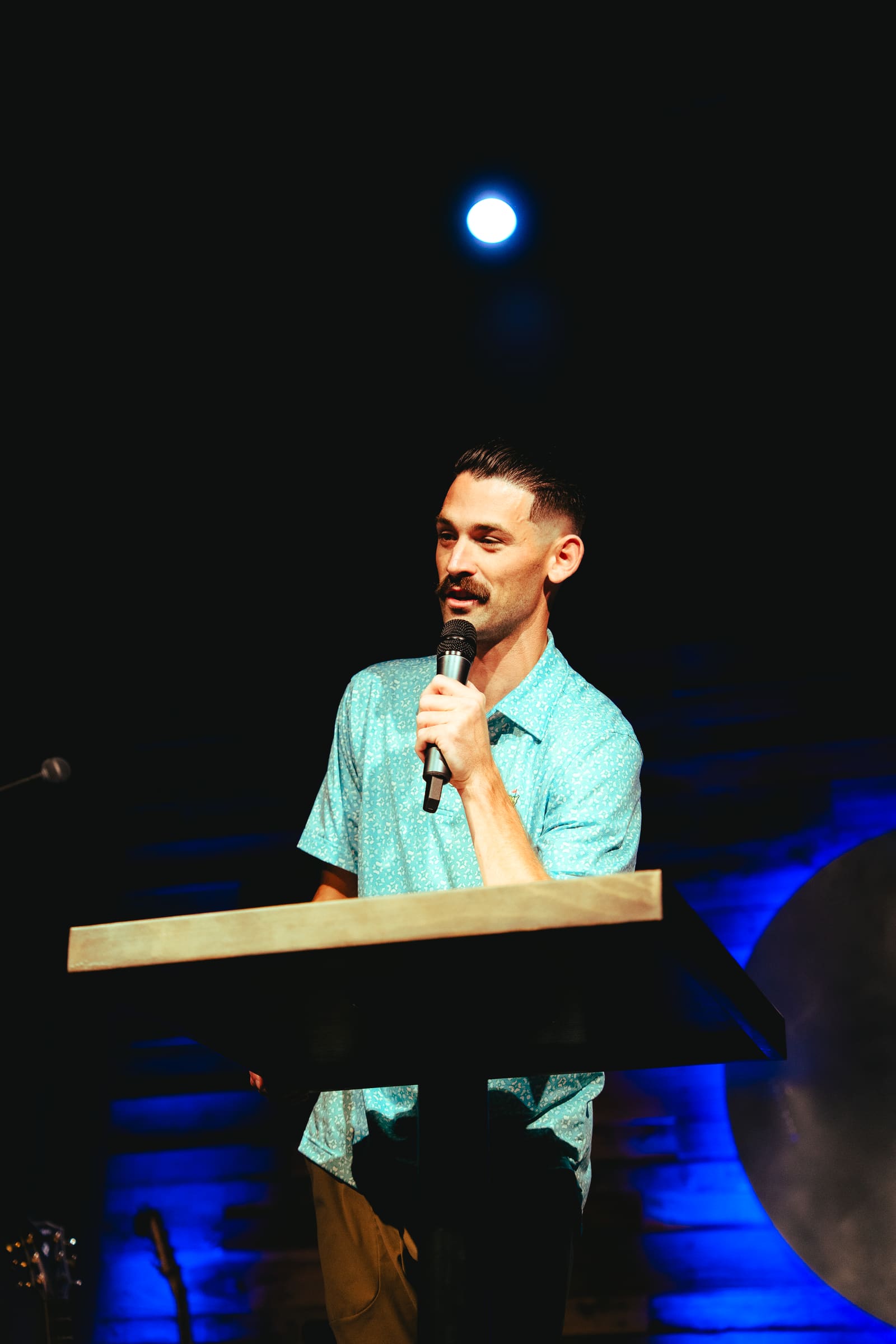 Evan Scofield speaking from the pulpit at a Victory Teens service
