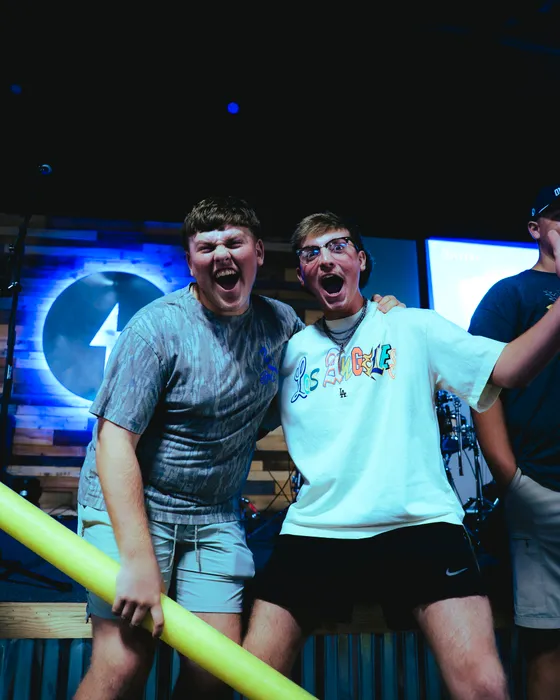 Two Victory Teens cheering together at a Wednesday night service