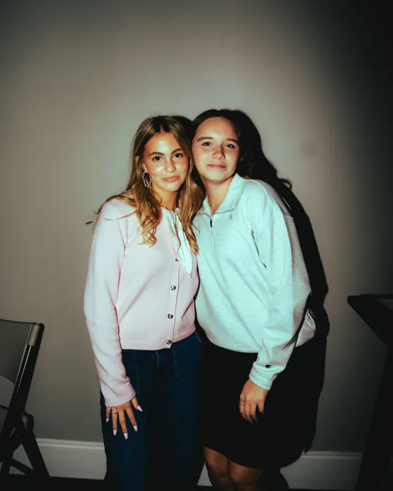 Two teen girls smiling together at church