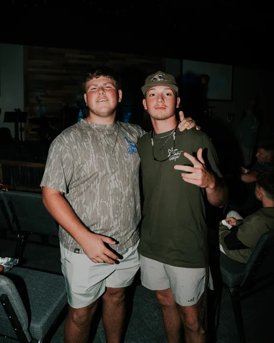 Two Victory Teens posing together after service