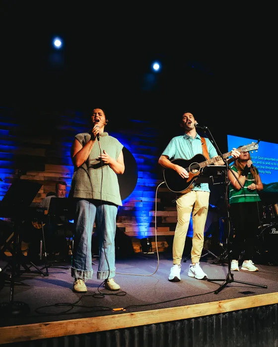 Two Victory Teens leading worship on stage