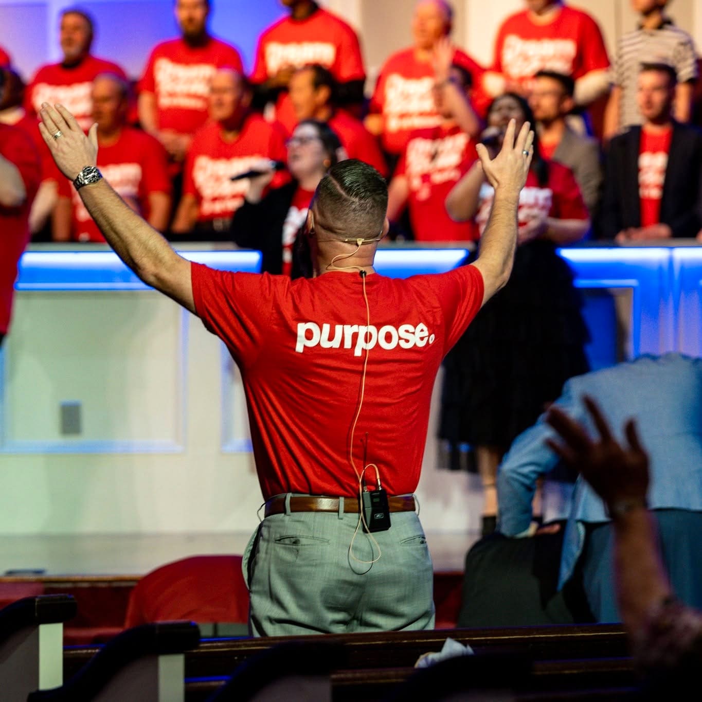 A Dream Team member wearing a red purpose shirt during a service