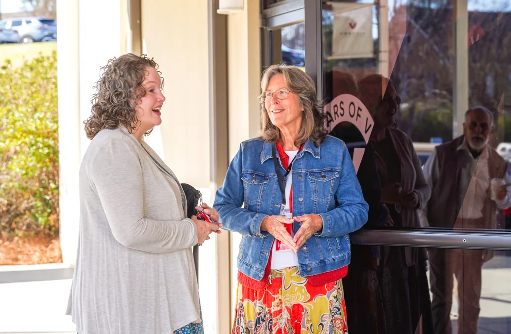 Two greeters welcoming guests at the Victory entrance