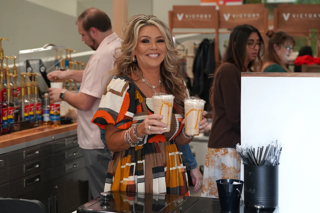 A Dream Team member serving iced drinks at the Victory cafe counter