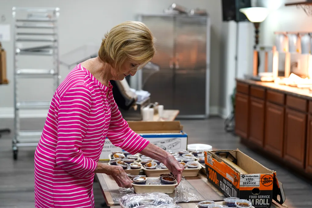 A culinary team member plating meals in the Victory kitchen