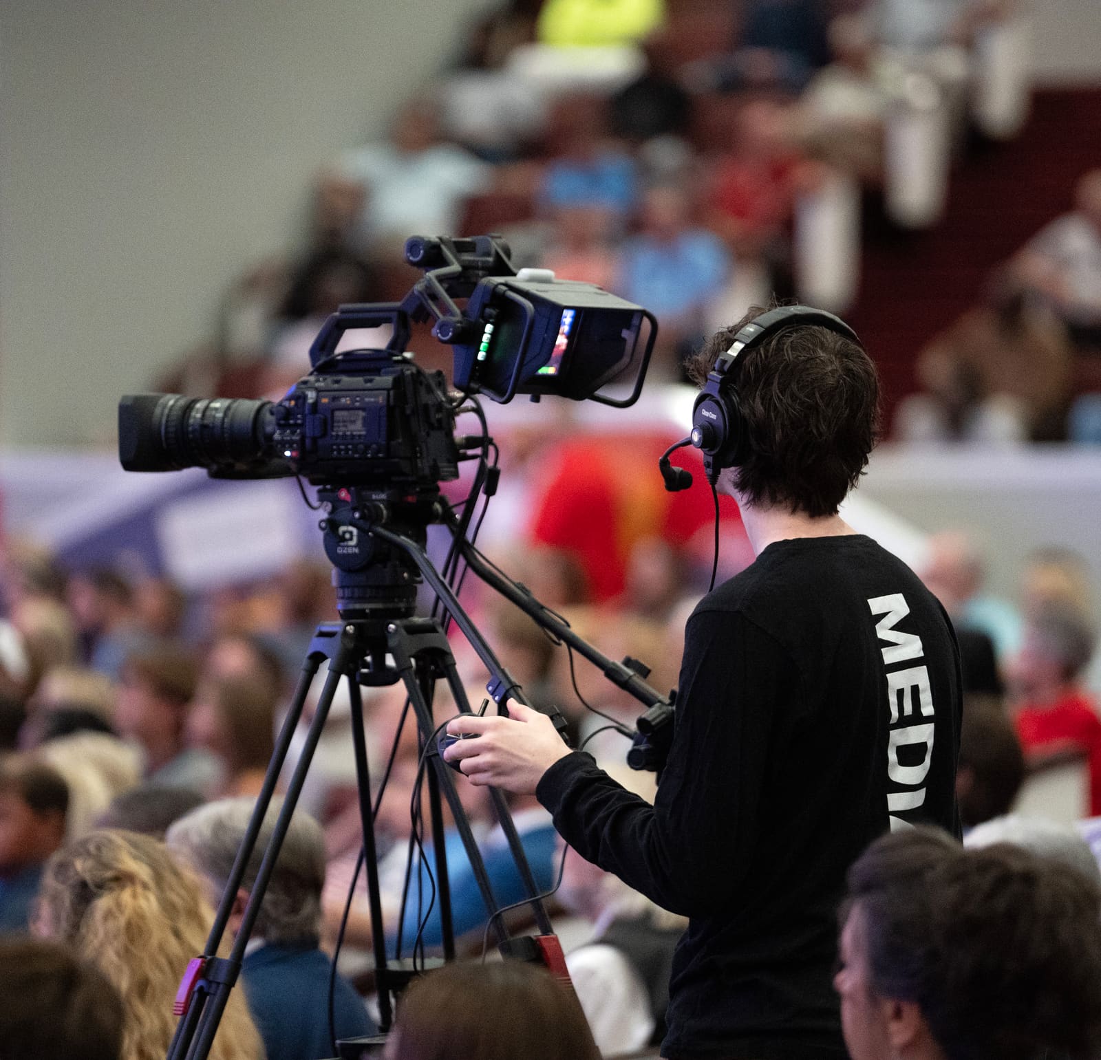 A Victory production team member running a camera during a Sunday service